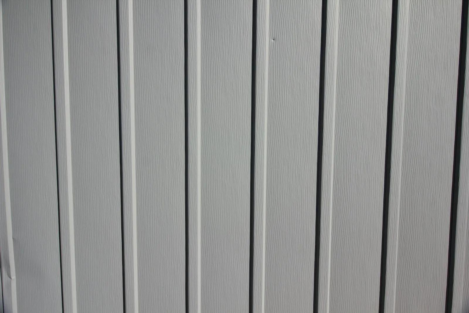 a close up of the side of a white fence