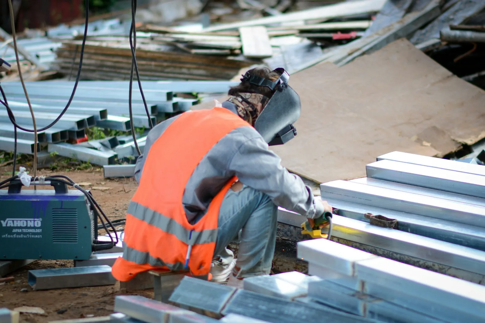a man wearing a safety vest working on a machine